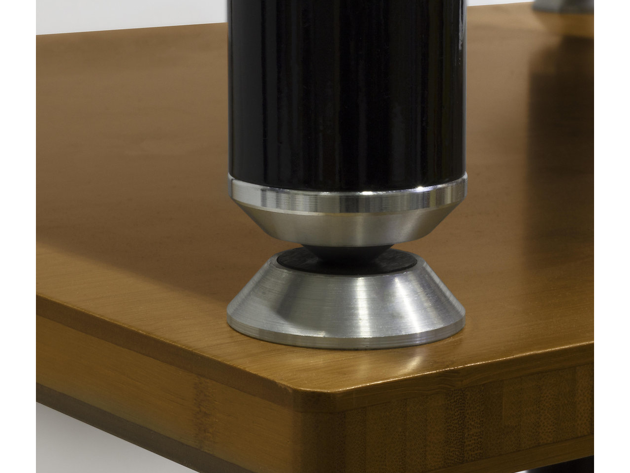 furniture leg, metal base, metallic, cylindrical leg, wooden surface